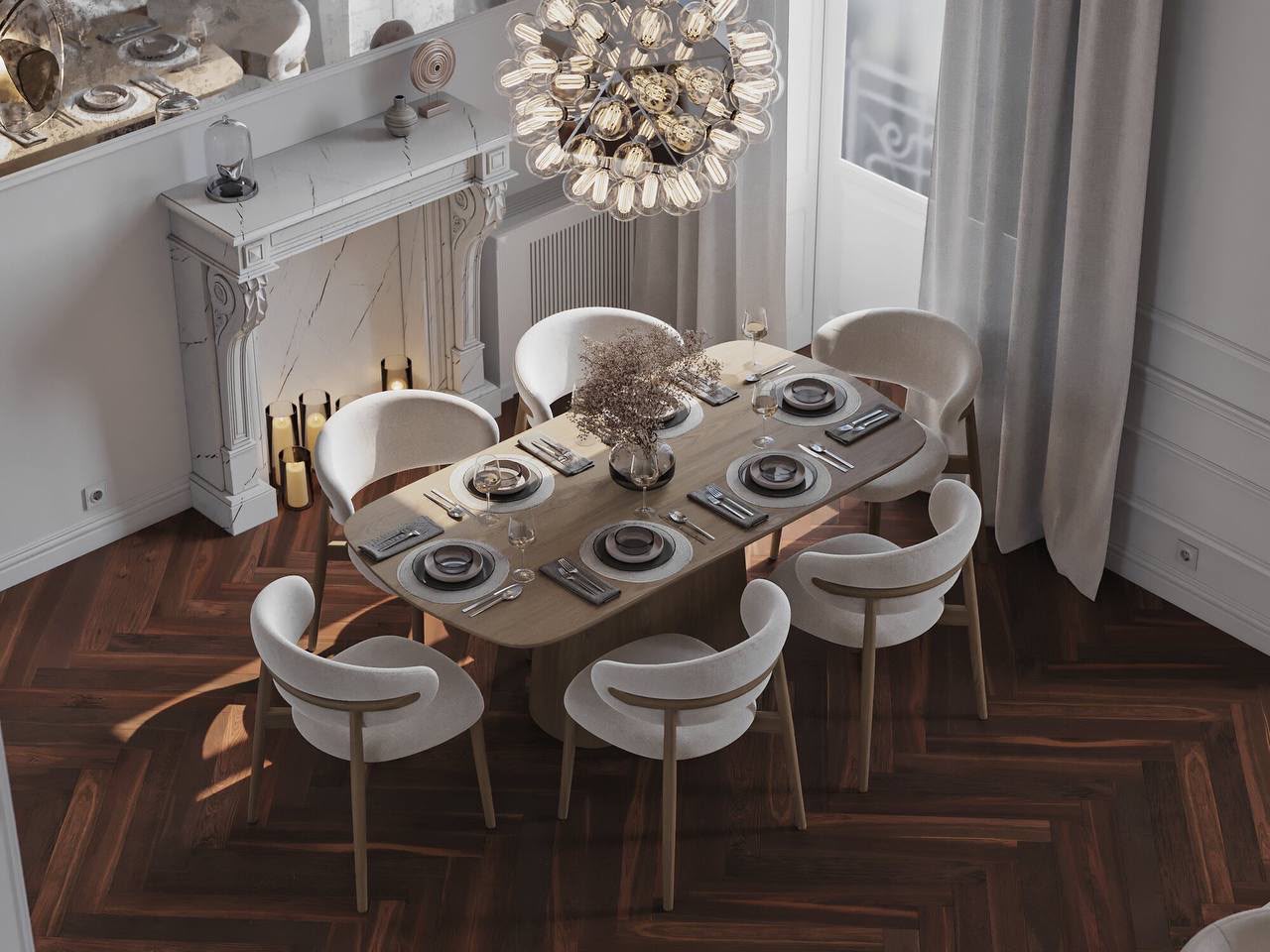 Dining table under a starburst chandelier, by the marble fireplace
