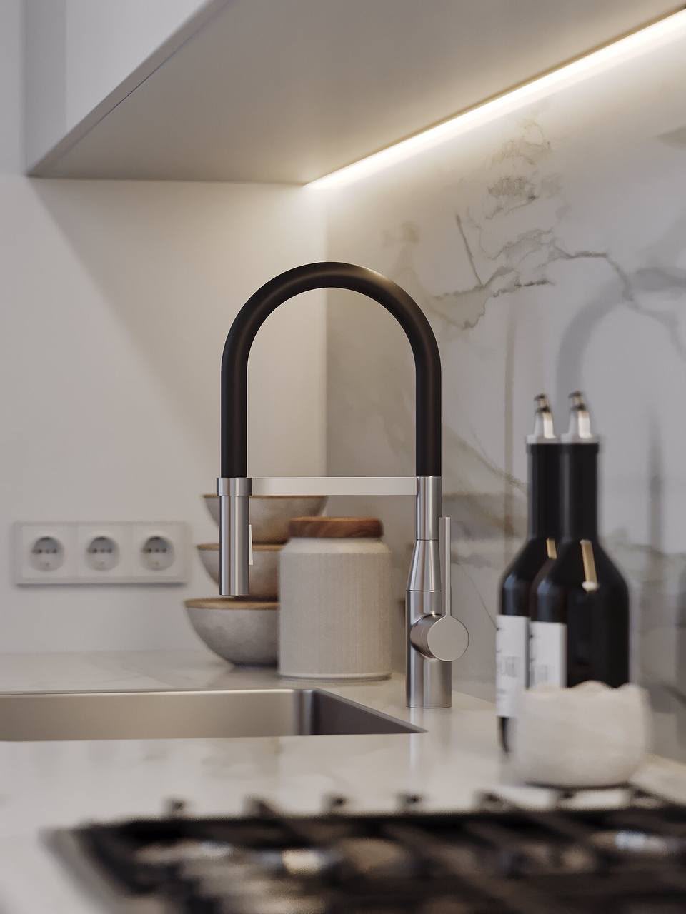 Kitchen detail: black mixer tap on a marble worktop