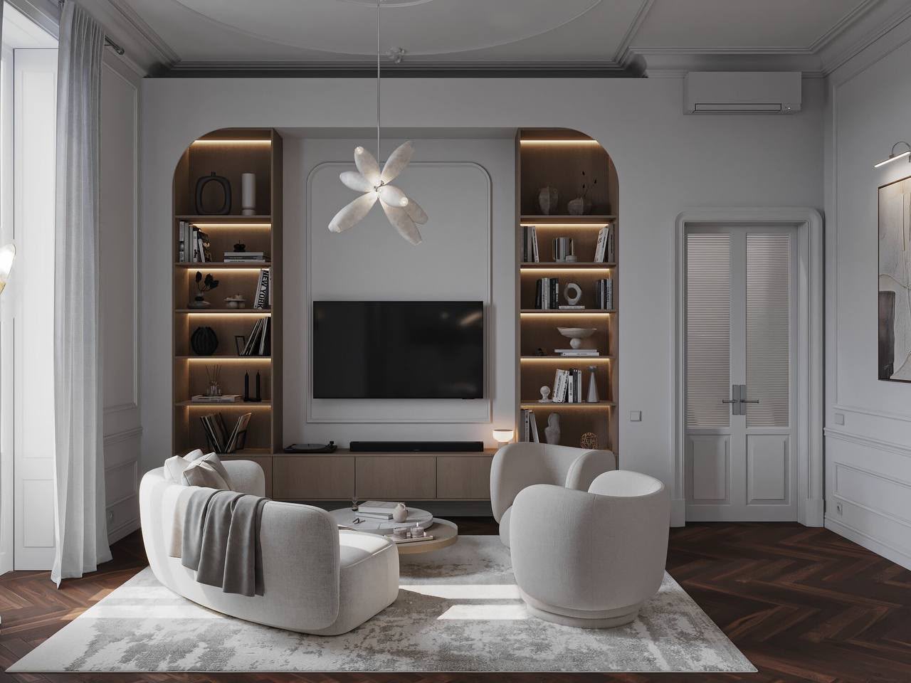 Living room: bouclé armchairs, arched bookcases and a sculptural pendant