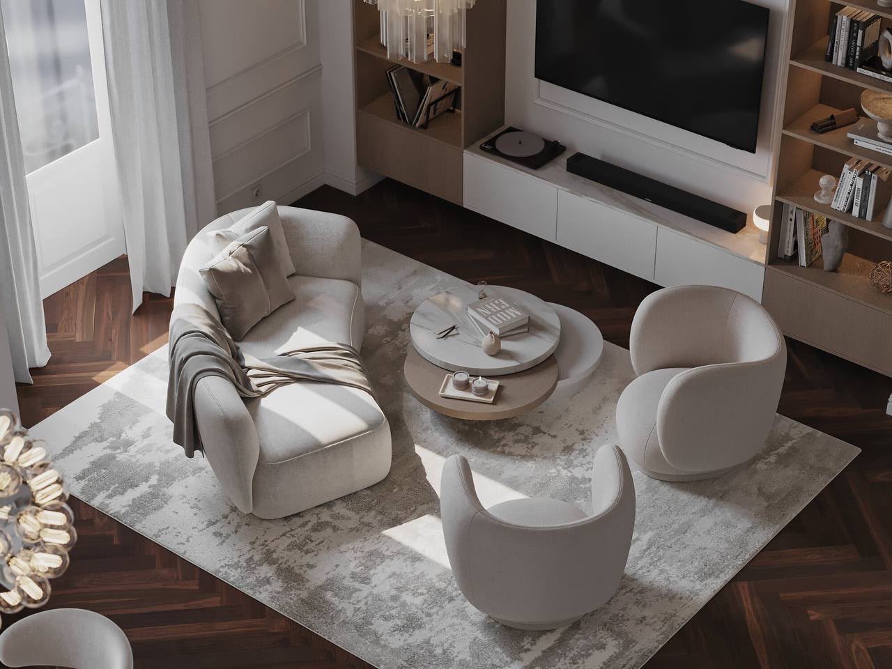 Armchairs gathered around a low table, TV wall framed in oak