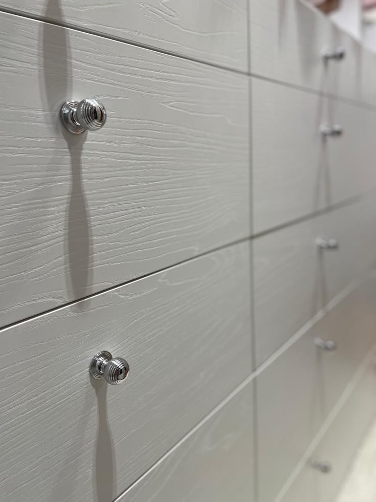Detail: crystal knobs on textured lacquered doors